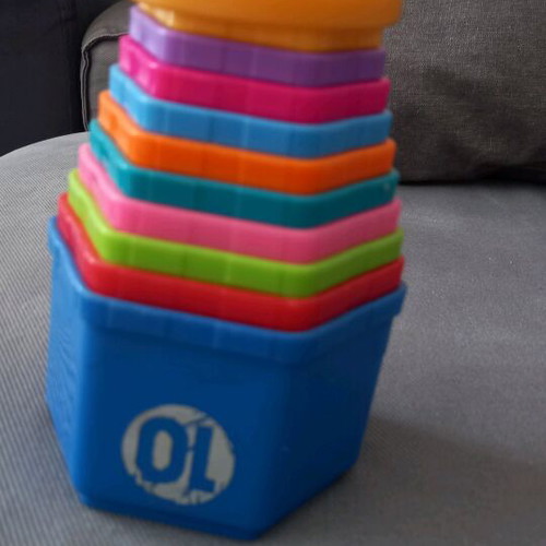 Activity toy pyramid with cups used