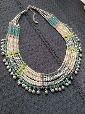 Accessorize multistrand necklace with plastic and glass beads