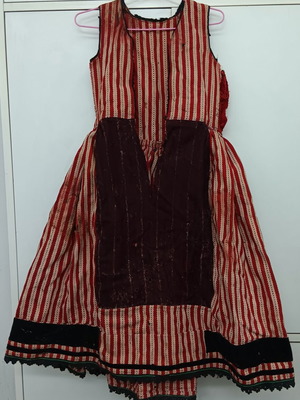 Collectible traditional orange wool dress of the era used