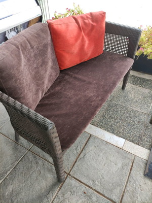 Almeco two-seater ratan sofa used outdoor with cushions