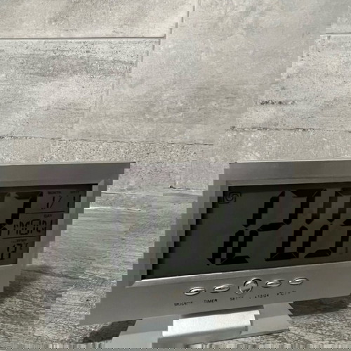 Digital table clock used with alarm and thermometer