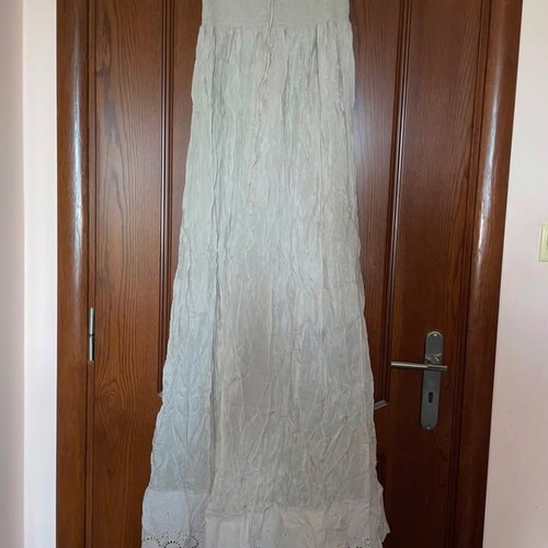 Long beige strapless dress used with honeycomb detail and neck tie