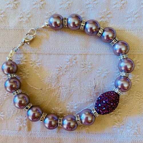 Handmade bracelet new with mauve glass pearls and purple decorative bead