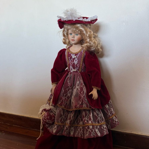 Porcelain doll with burgundy velvet dress like new