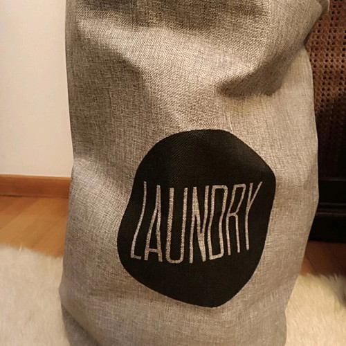 Fabric laundry basket like new with closing strap, gray
