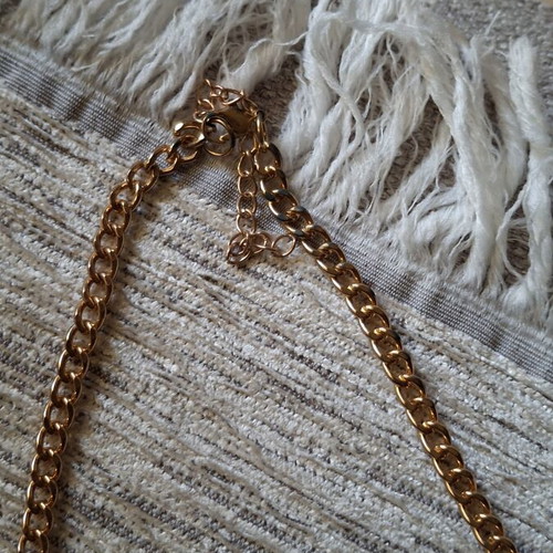 Gold necklace like new with black and gold chains and tassels