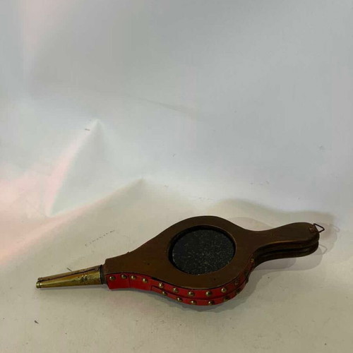 Vintage wall thermometer shaped like a fireplace bellows used