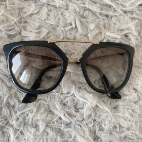 Prada sunglasses in black with gold details