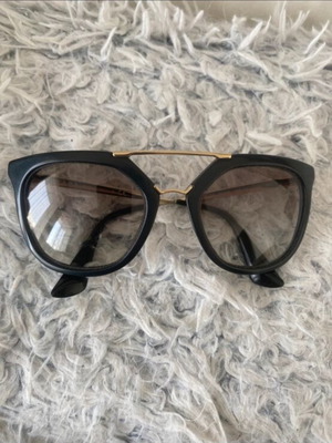 Prada sunglasses in black with gold details