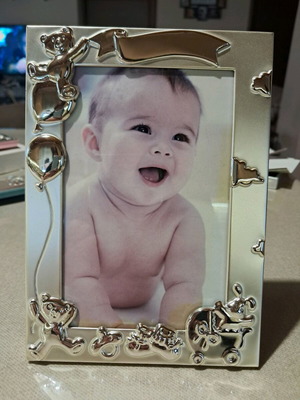 Silver-plated children's photo frame with embossed designs, like new, 10x15