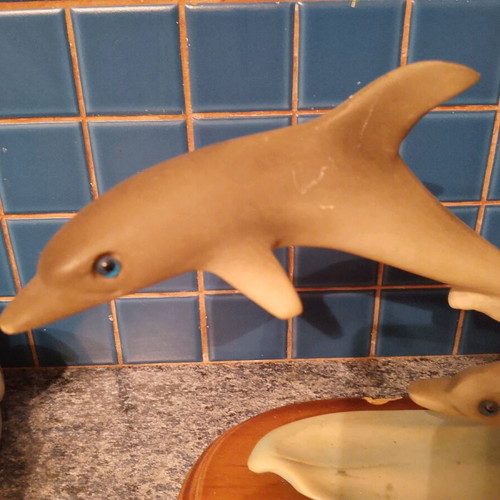 Vintage retro dolphin sculpture with wooden base used