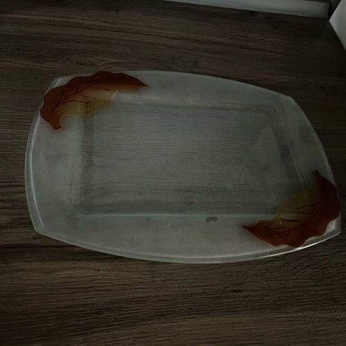 Decorative glass tray used with embossed leaf design