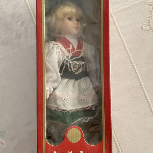 Porcelain doll with traditional costume green and red like new
