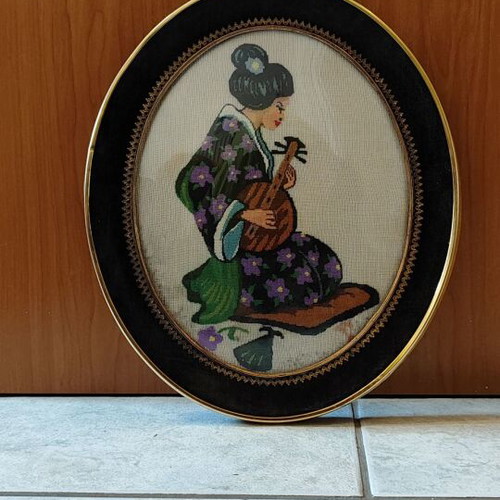 Embroidered painting with Asian woman used, curved glass