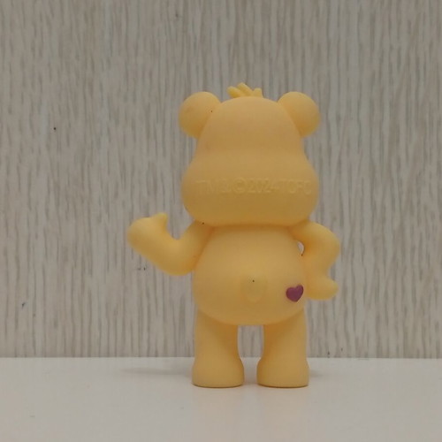 Care Bears Yellow Love-A-Lot Bear figure used with red heart