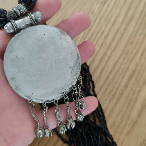 Long necklace with round pendant and bells, like new