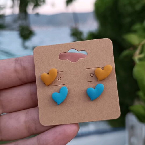 Heart-shaped polymer clay earrings with steel posts, orange and turquoise