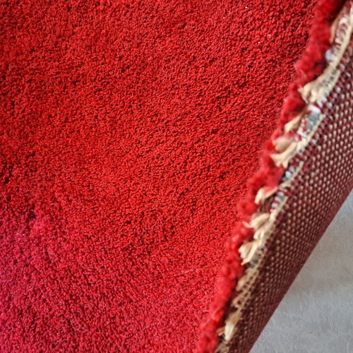 Shaggy red rugs with high pile, 2 rectangular and 1 round