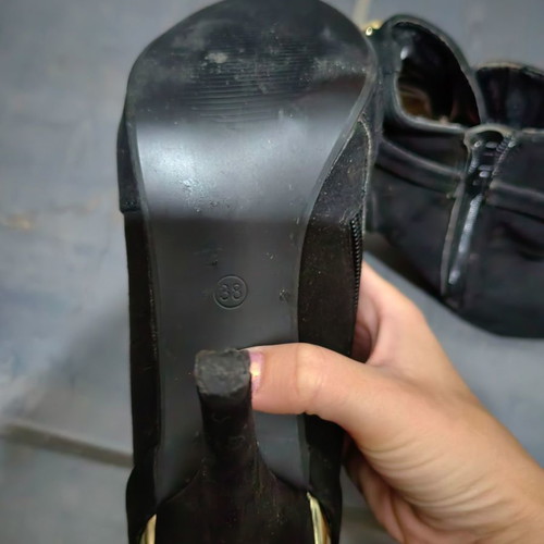 High-heeled ankle boot used, black with gold details
