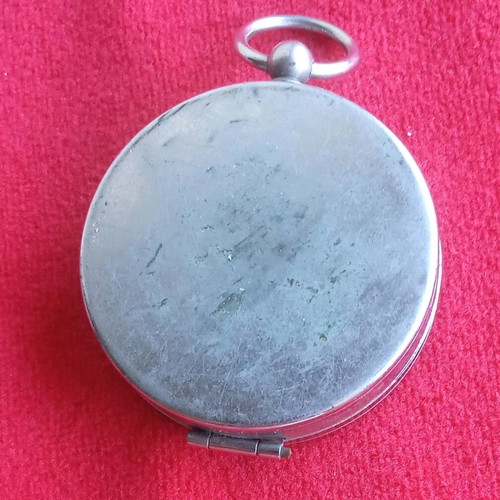 Vintage pocket compass used with metal casing