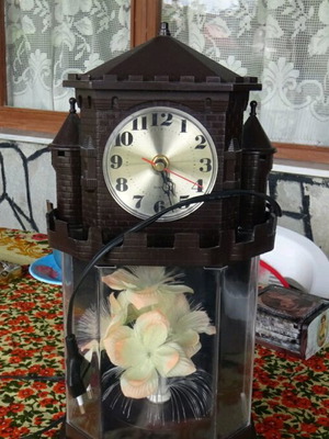 Table clock used collectible with lighting and rotating flower