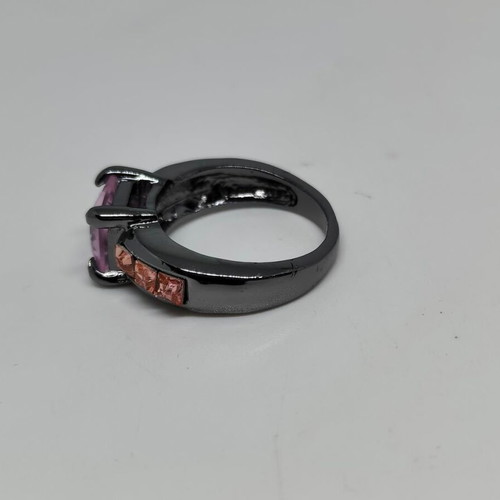 Ring with purple central crystal and pink details in black metal like new
