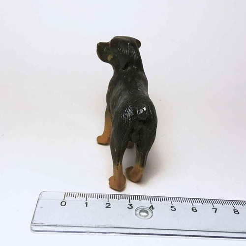 Plastic dog figure used with scratches and marks