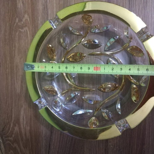 Crystal ashtray used, heavy with embossed gold-plated designs