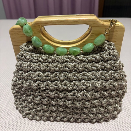 Handmade knitted beige bag with wooden magnetic clasp and beaded handle