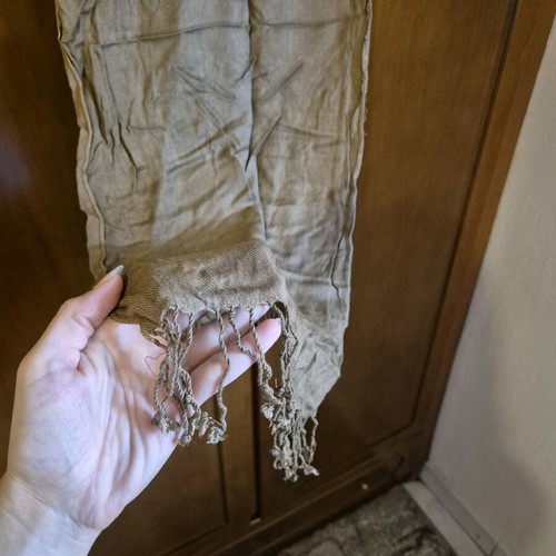 Scarf used in brown and beige tones with fringed edges