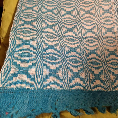 Handmade wool woven blanket used with knitted lace
