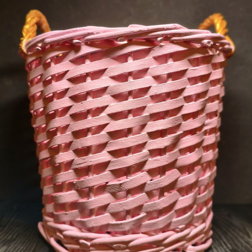 Decorative pink rattan basket with gold handles, handmade