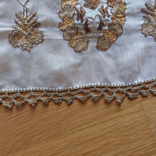 Embroidered table runner used with gold thread and lace