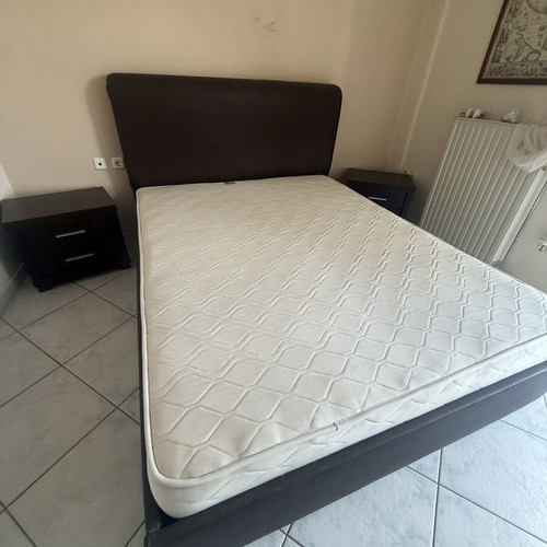 Double bed with brown leatherette upholstery, storage and lift mechanism