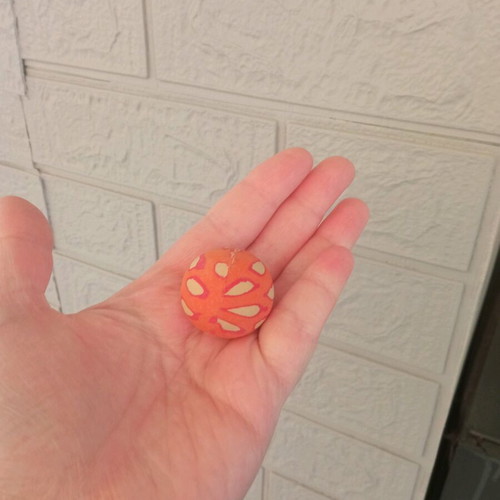 Small orange ball used with design