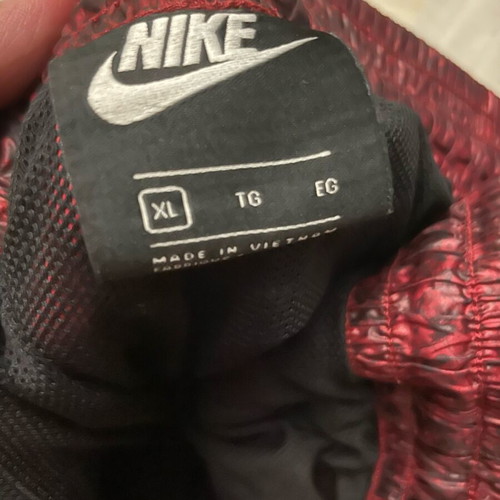 Nike snake print pants with signs of wear