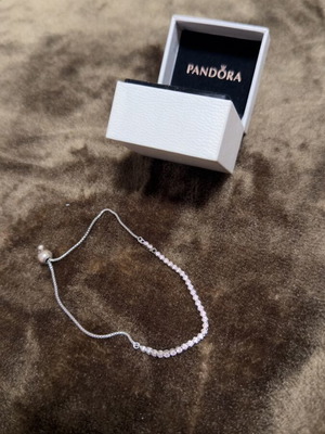 Pandora bracelet used, pink tone, missing one stone