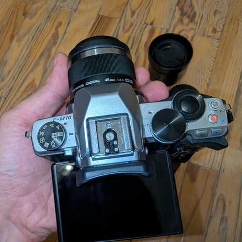 Olympus OM-D E-M10 camera with 2 prime lenses and accessories