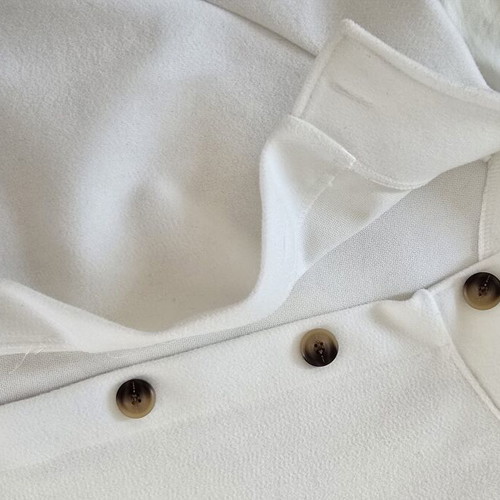 White short jacket with stand-up collar and buttons, minimal style