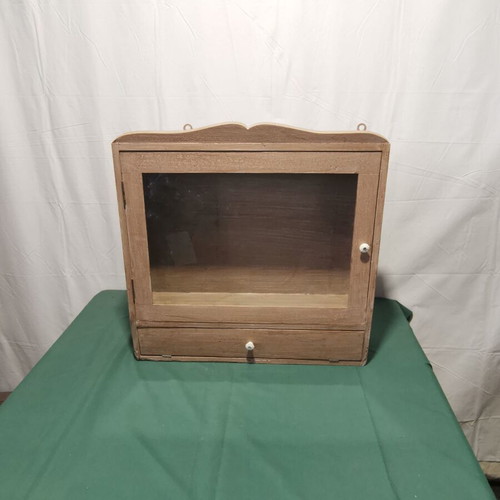 Hanging display cabinet used with glass and storage space, 1960