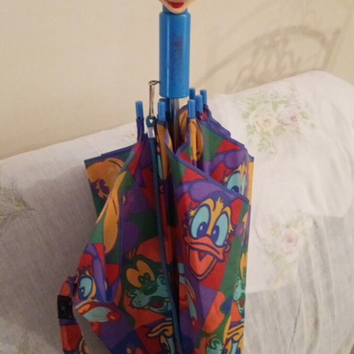 Disney umbrella used with blue Mickey Mouse handle, multicolored