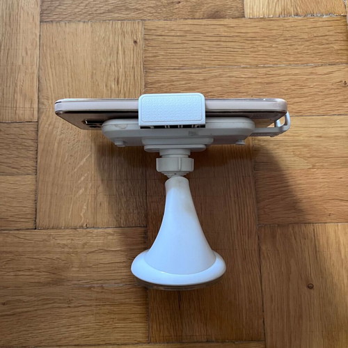 White mobile phone holder used with strong suction cup for car