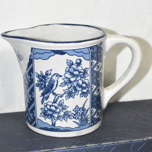 Vintage ceramic jug blue and white with bird and floral motifs used