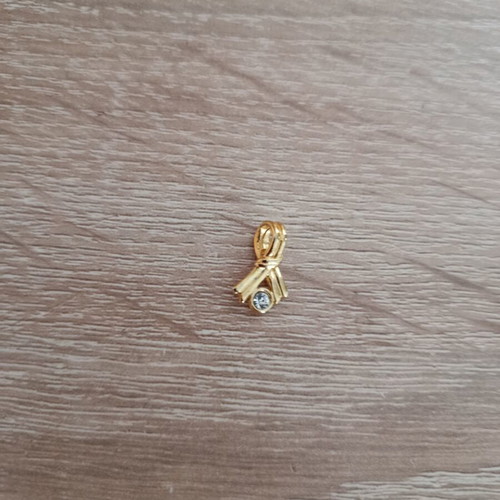 Gold-colored pendant with white stone used, vintage style