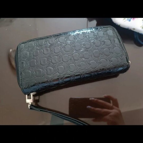 Patent leather wallet like new with embossed design and wrist strap