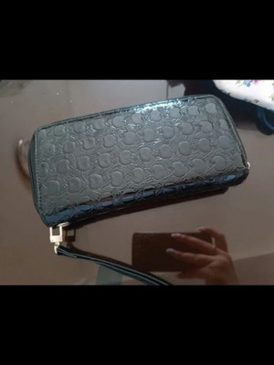 Patent leather wallet like new with embossed design and wrist strap