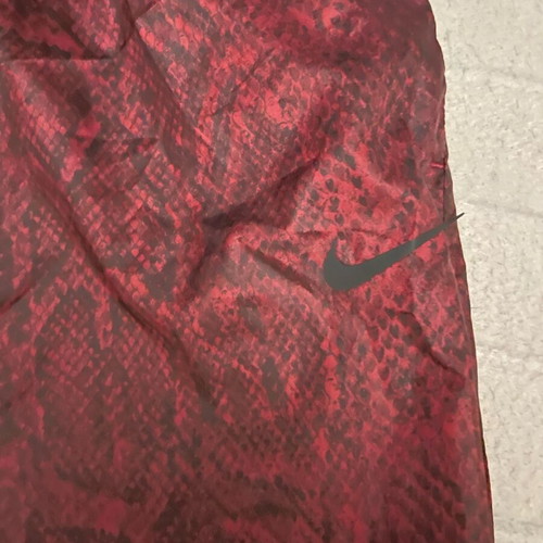 Nike snake print pants with signs of wear