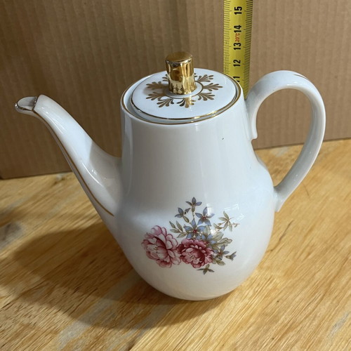 Porcelain tea set used with floral pattern, teapot, creamer, sugar bowl