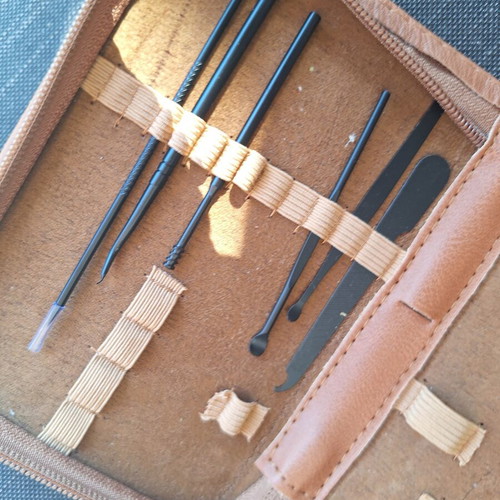 Skin and nail care tools set in small brown case