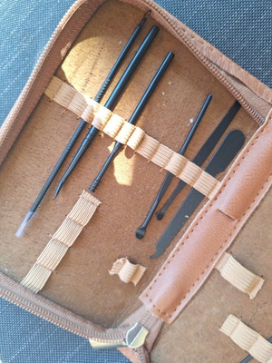 Skin and nail care tools set in small brown case